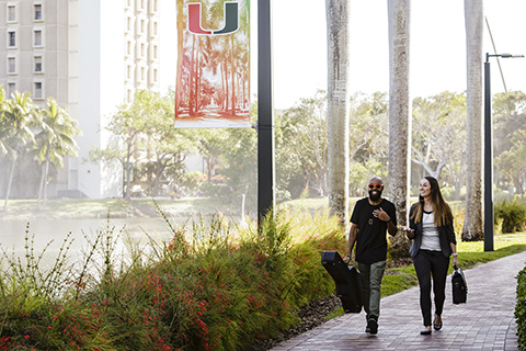 Two students walking to class at the University of Miami Coral Gables campus